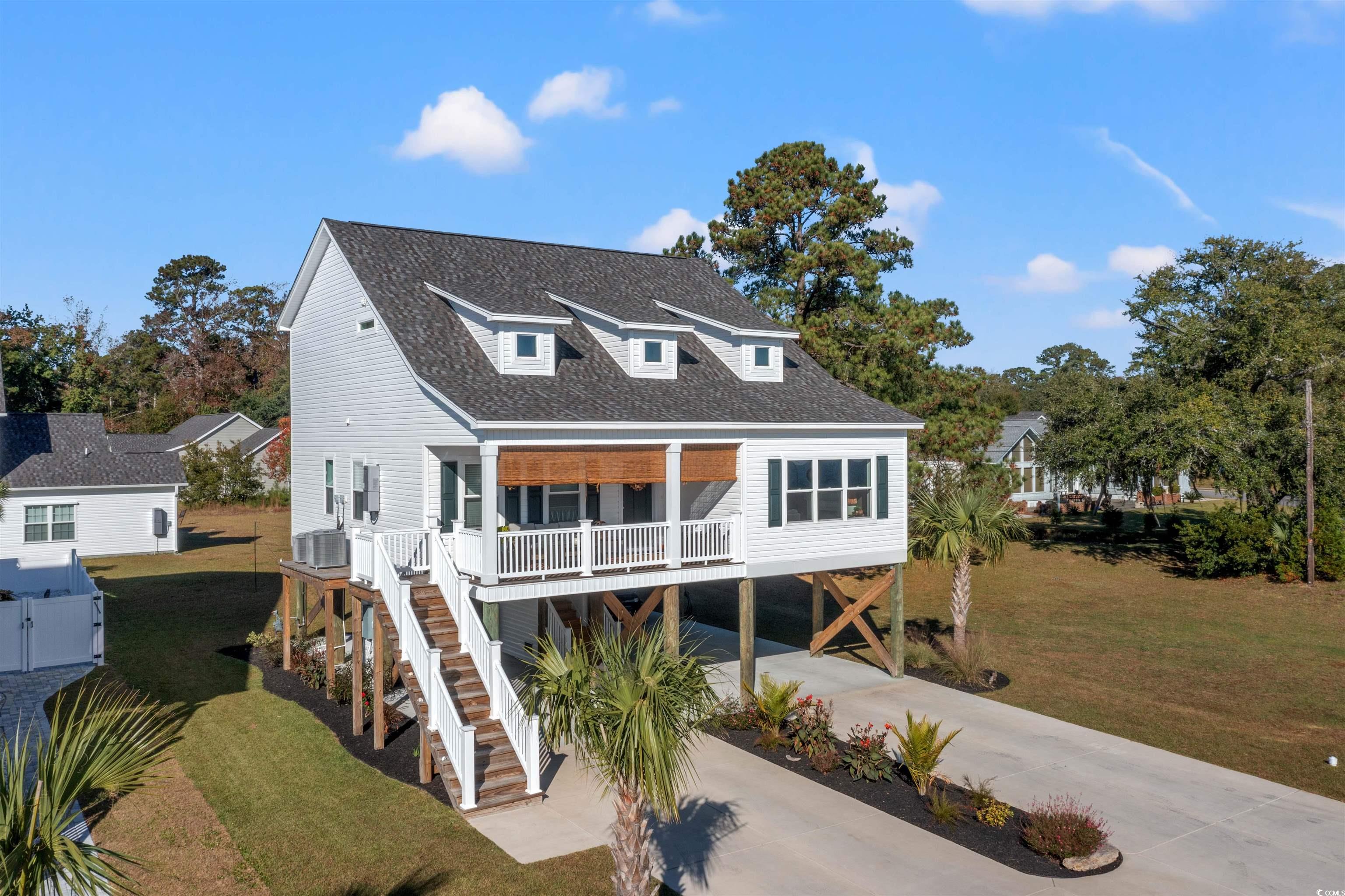 2664 Seaport Circle Georgetown, SC 29440 - Photo 2 of 40 View of front facade featuring a carport, a front lawn, roof with shingles, and concrete driveway