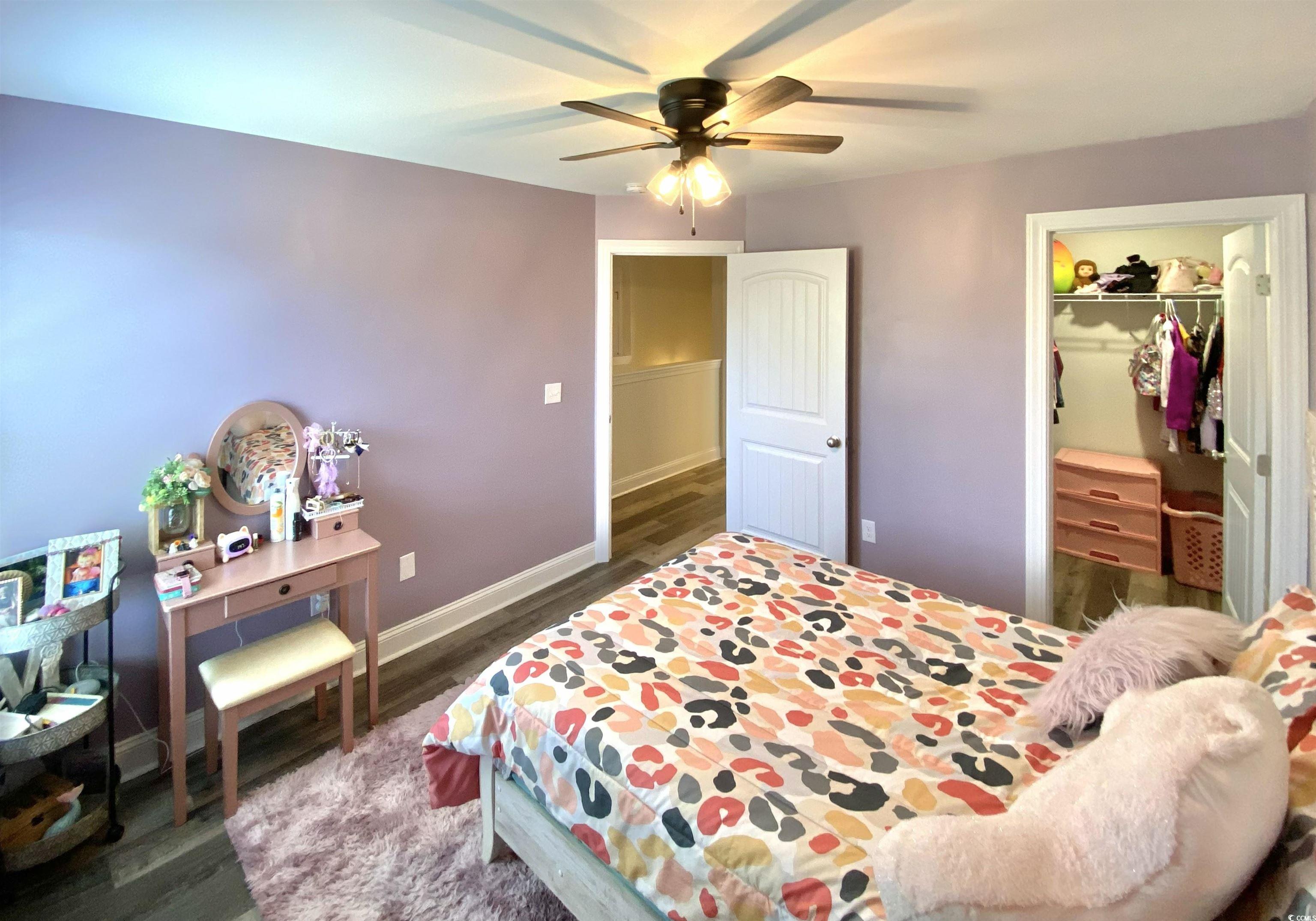 2664 Seaport Circle Georgetown, SC 29440 - Photo 28 of 40 Bedroom with dark wood-style floors, a spacious closet, and ceiling fan