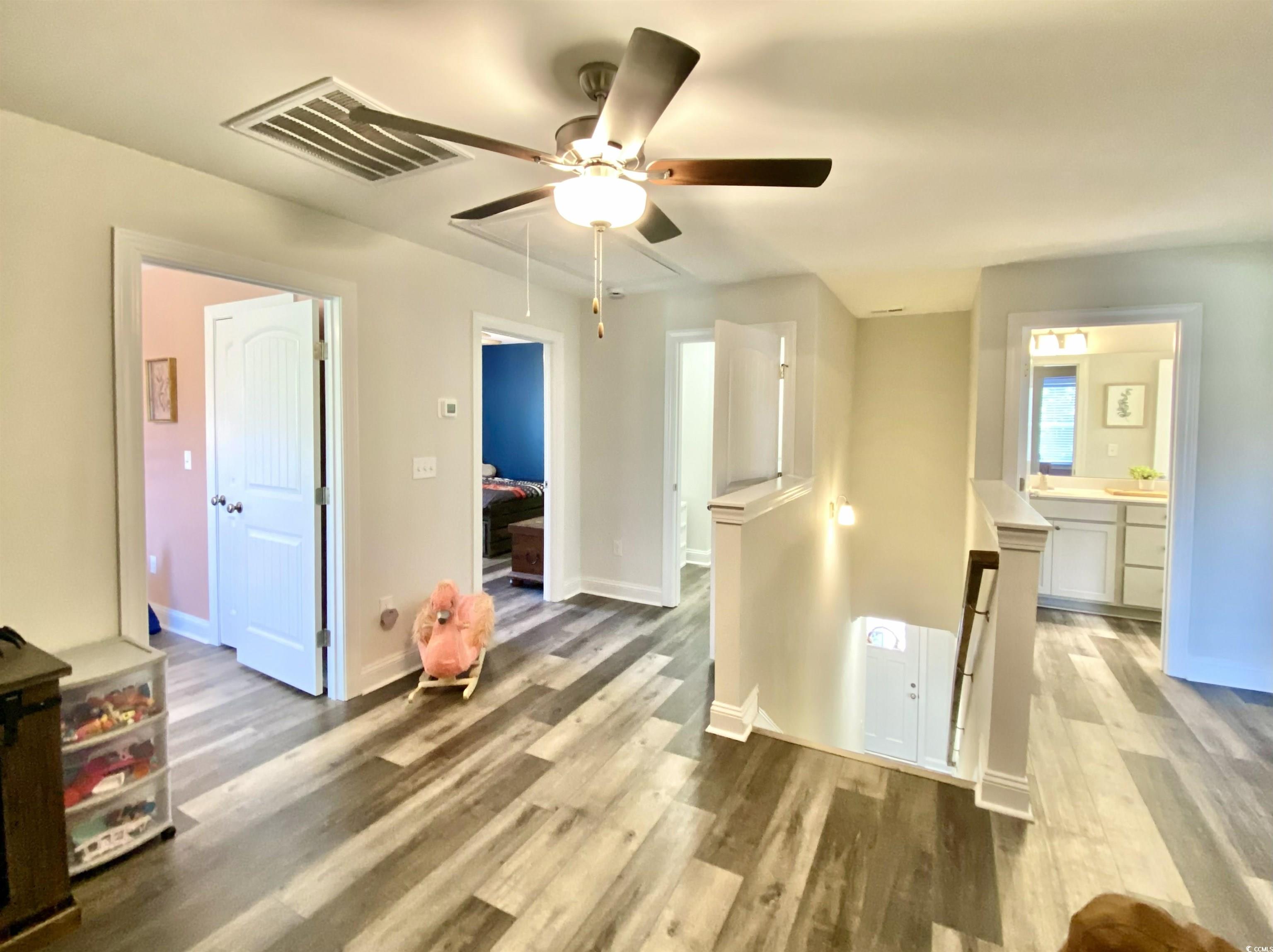 2664 Seaport Circle Georgetown, SC 29440 - Photo 33 of 40 Unfurnished bedroom with light wood finished floors, a ceiling fan, and attic access