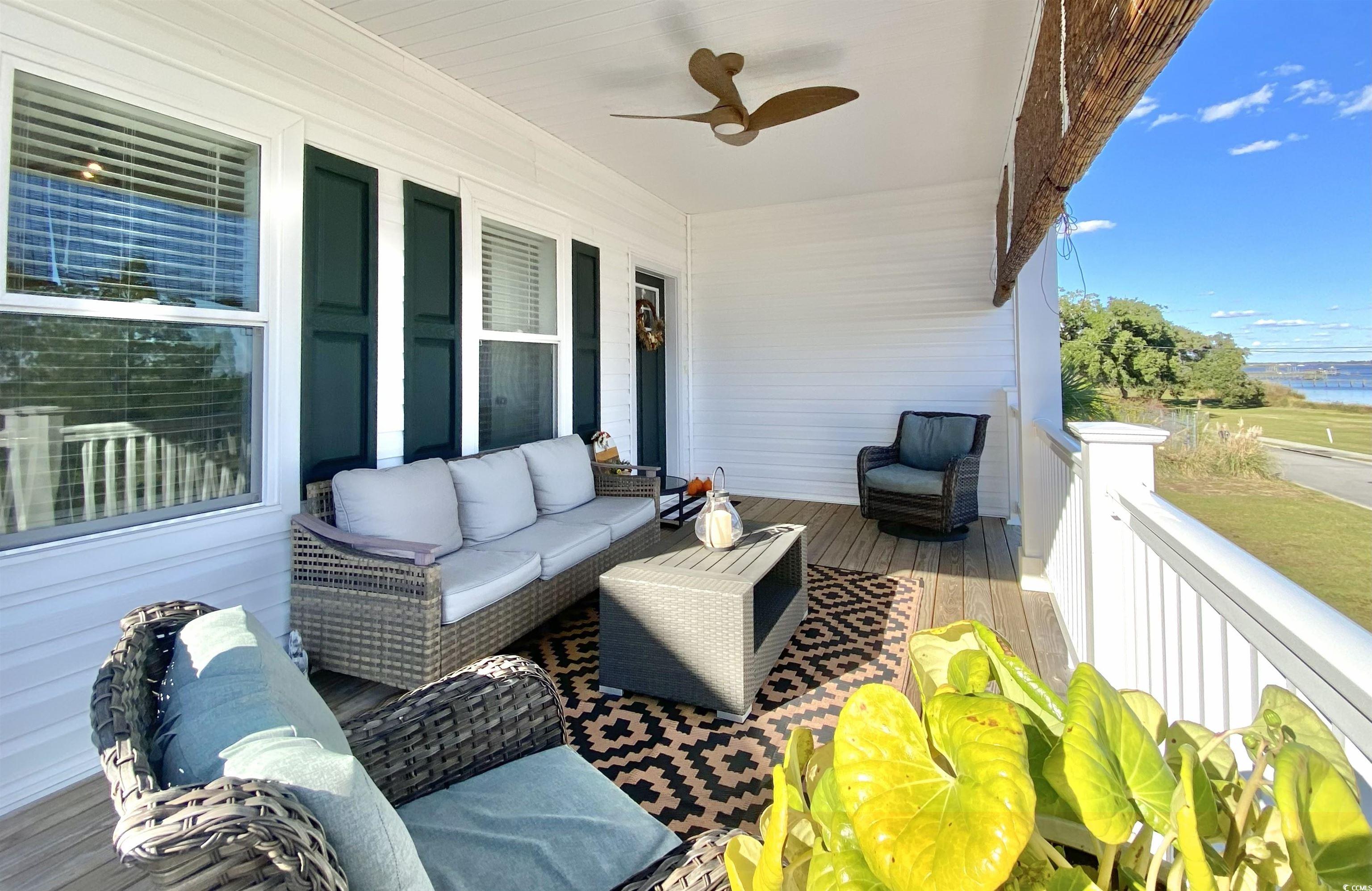 2664 Seaport Circle Georgetown, SC 29440 - Photo 4 of 40 Balcony featuring an outdoor hangout area, a ceiling fan, and a water view