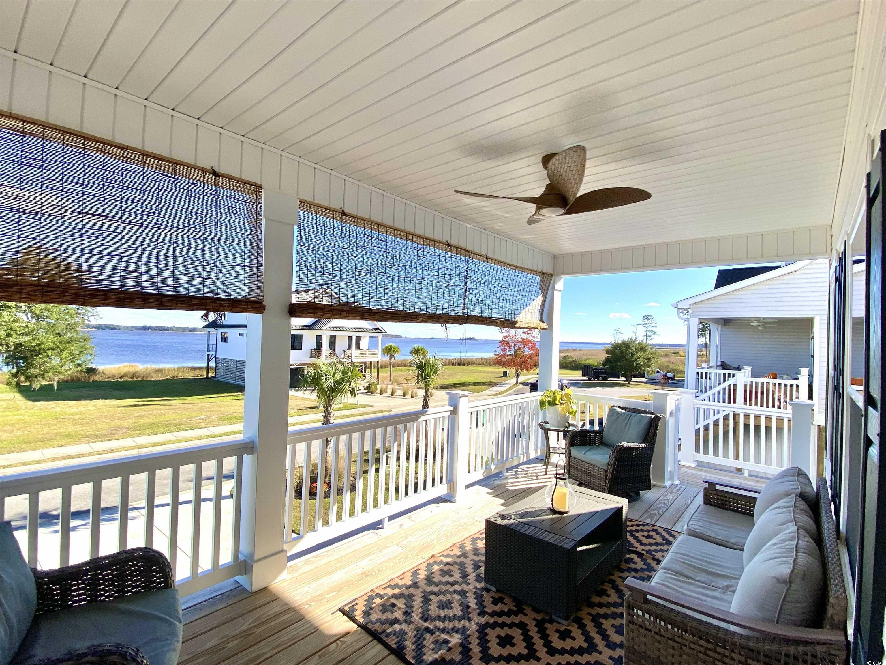 2664 Seaport Circle Georgetown, SC 29440 - Photo 6 of 40 Deck with ceiling fan, an outdoor living space, and a water view