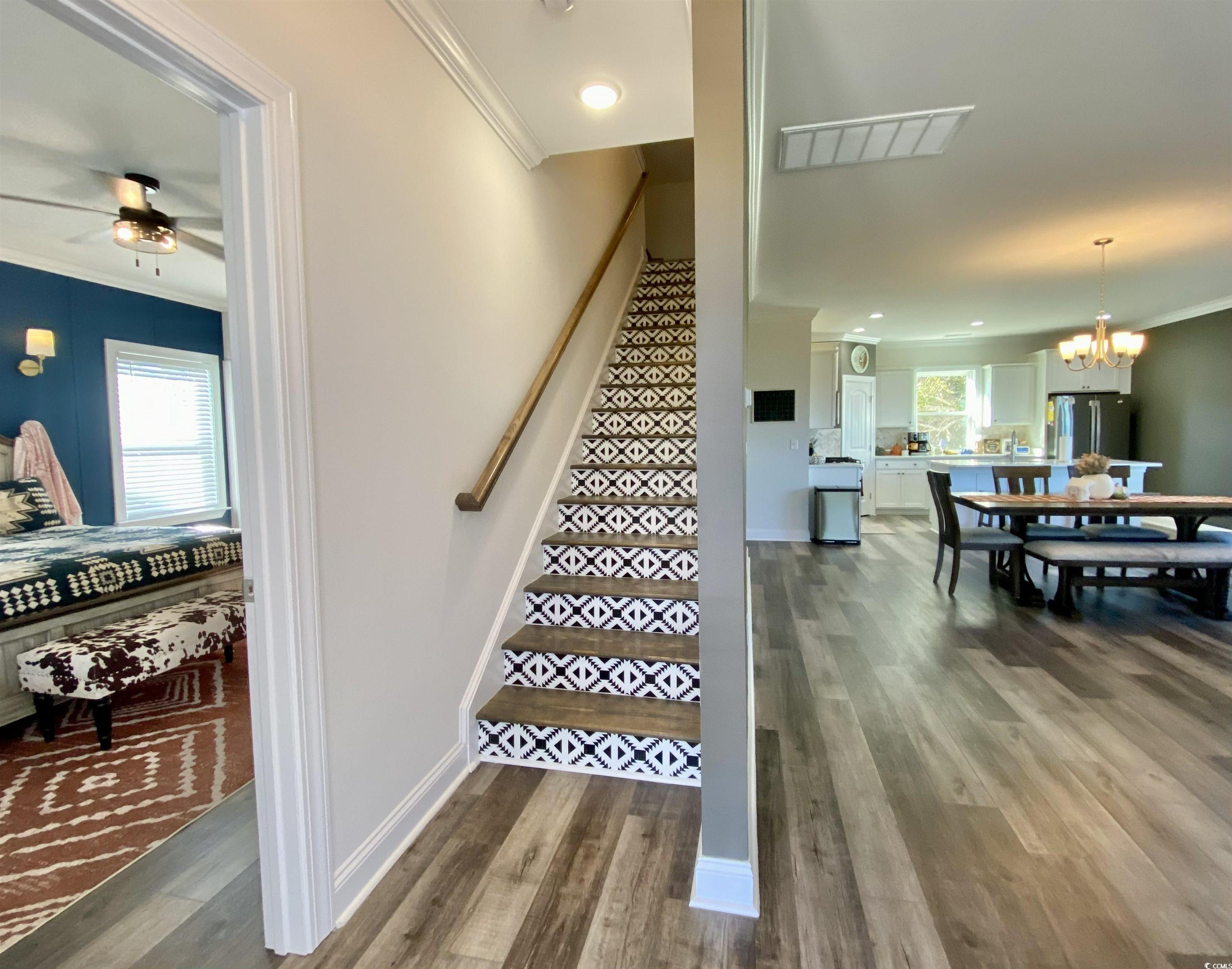 2664 Seaport Circle Georgetown, SC 29440 - Photo 8 of 40 Stairway featuring crown molding, wood finished floors, a chandelier, ceiling fan, and recessed lighting