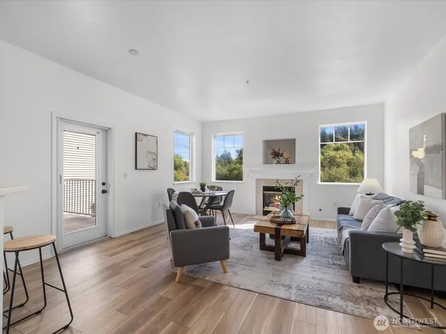 a living room with furniture kitchen and a potted plant