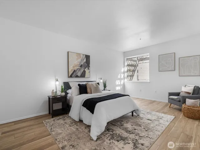 a bedroom with a bed and wooden floor