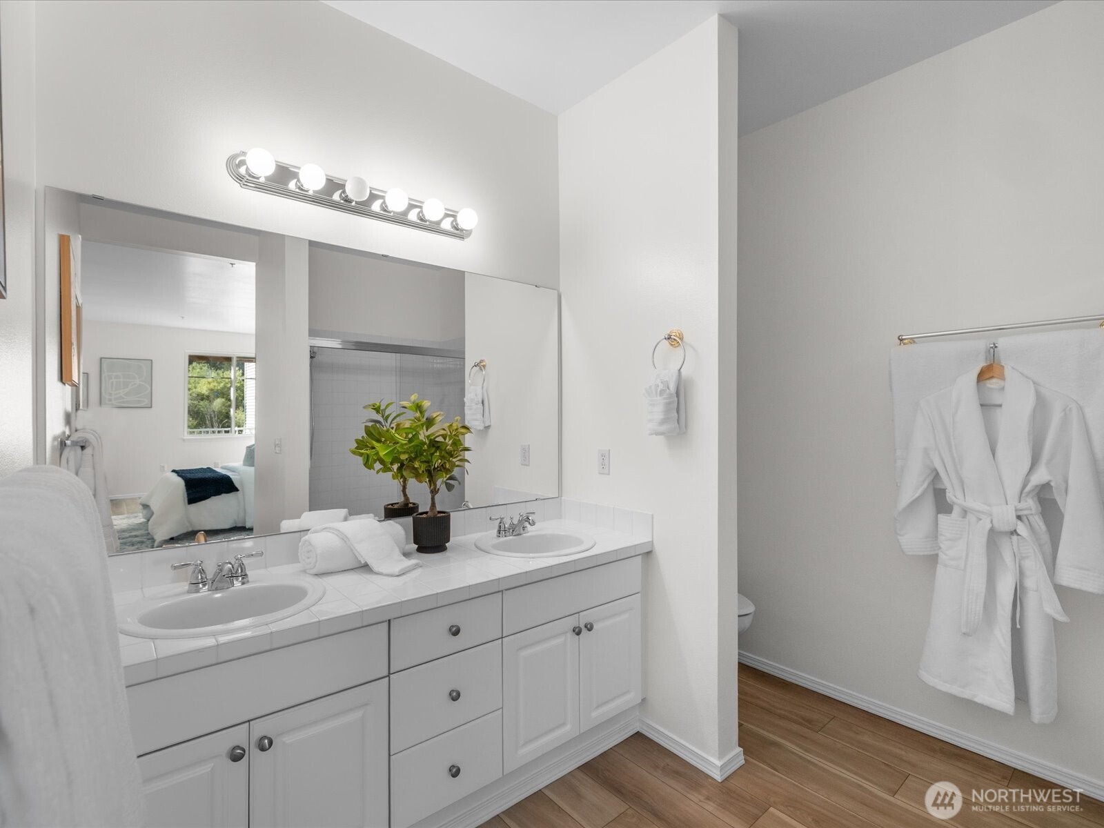 17426 Bothell Way Northeast, Unit A407 Bothell, WA 98011 - Photo 17 of 36 a bathroom with a double vanity sink a mirror and a shower