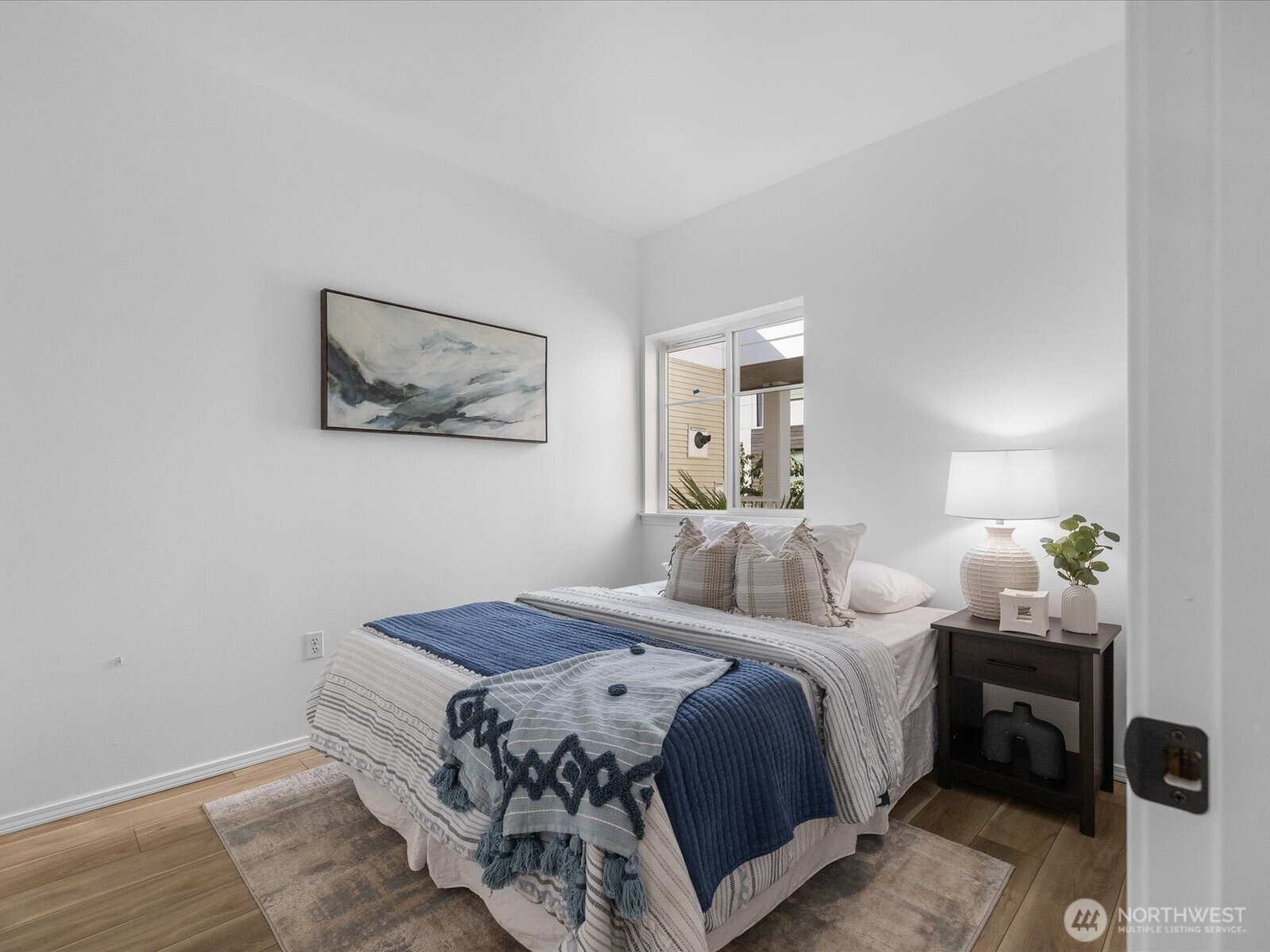 17426 Bothell Way Northeast, Unit A407 Bothell, WA 98011 - Photo 21 of 36 a bedroom with a bed and a painting on the wall