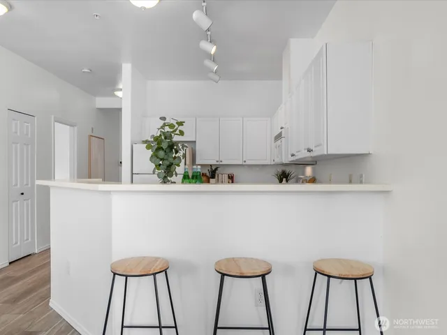 a view of kitchen island with cabinets and window