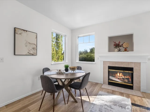 a living room with furniture dining table and a fireplace