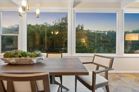a view of a dining room with furniture window and outside view