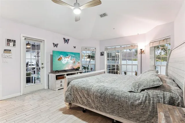 a bedroom with a large bed and a flat screen tv