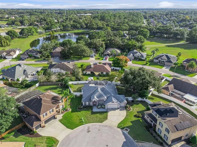 an aerial view of a house with a garden and swimming pool