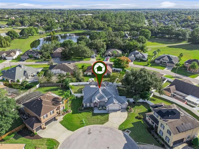 an aerial view of a house with a swimming pool yard and outdoor seating