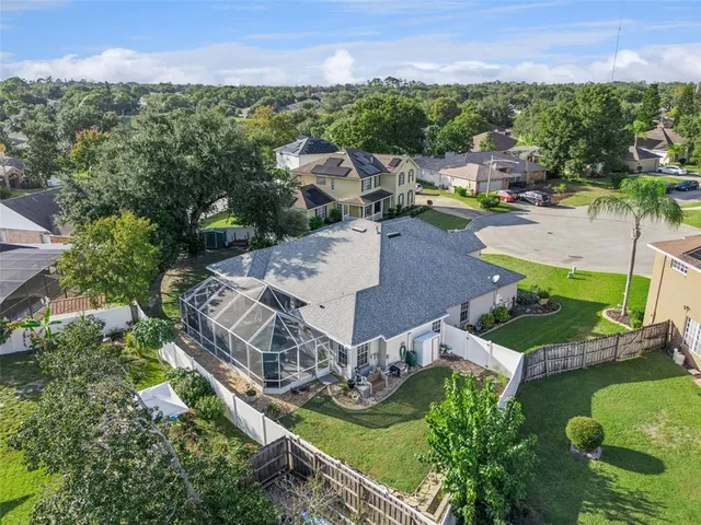 an aerial view of a house with a garden and lake view