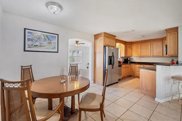 a kitchen with stainless steel appliances a table and chairs