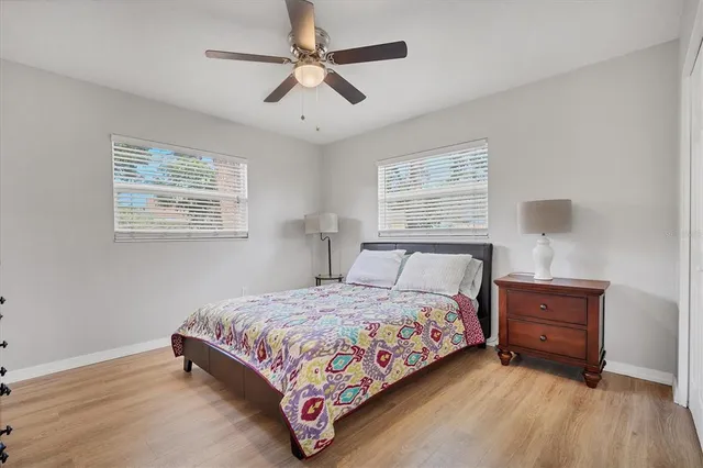 a bedroom with a bed chandelier and a window
