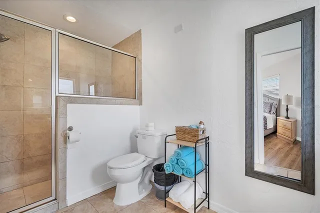 a bathroom with a toilet and a shower