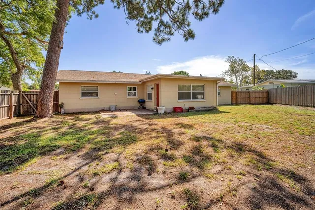 a view of a house with a backyard
