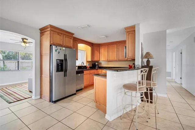 a kitchen with refrigerator and cabinets