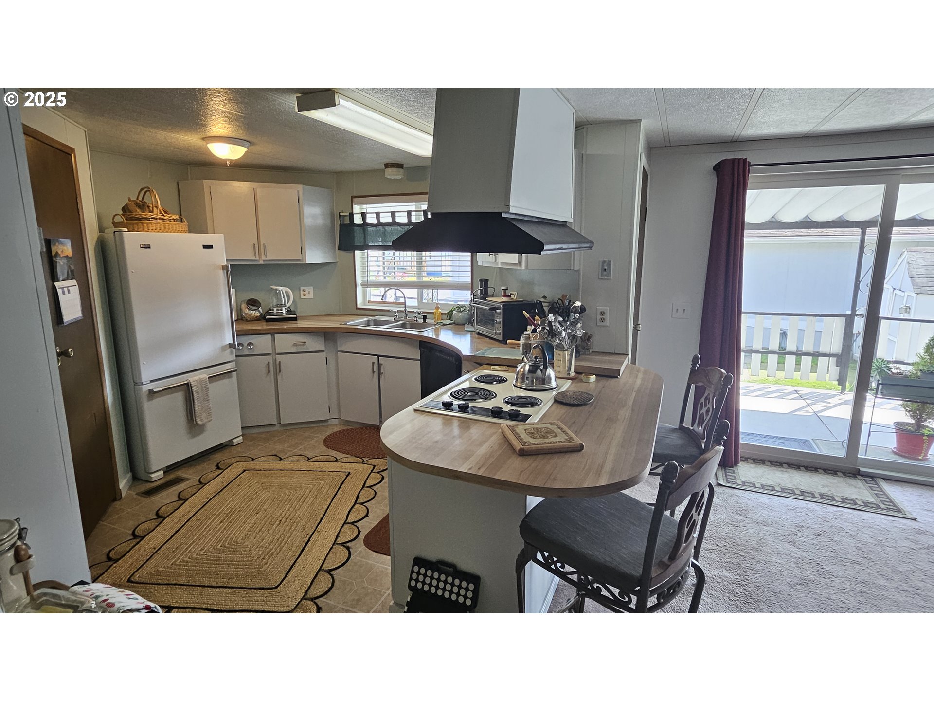 5600 Mt Solo Road Longview, WA 98632 - Photo 2 of 17 a kitchen with stainless steel appliances kitchen island granite countertop a table and chairs in it