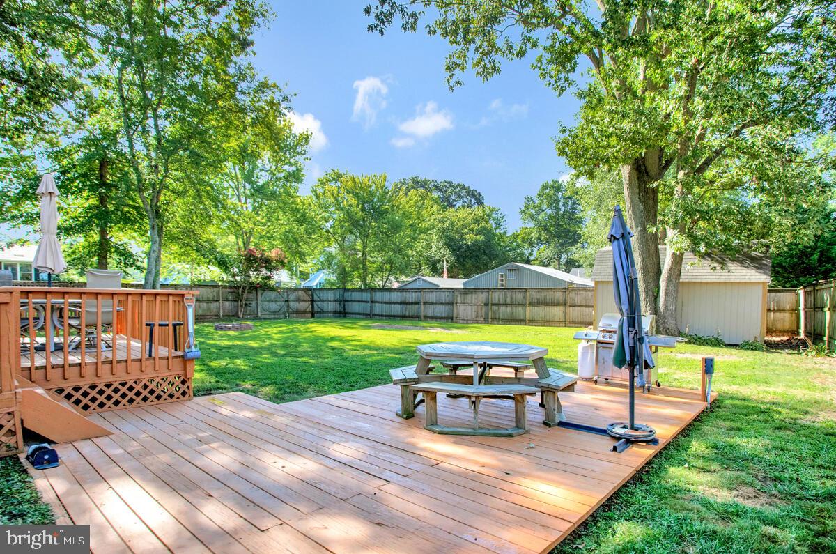 a view of a swimming pool and lounge chairs in the patio