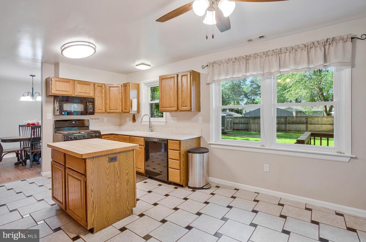 645 Gull Drive Deale, MD 20751 - Photo 15 of 41 a kitchen with granite countertop a stove a sink and a refrigerator