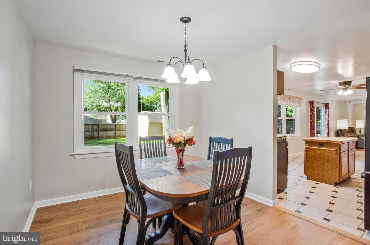 645 Gull Drive Deale, MD 20751 - Photo 19 of 41 a dining room with furniture a chandelier and wooden floor