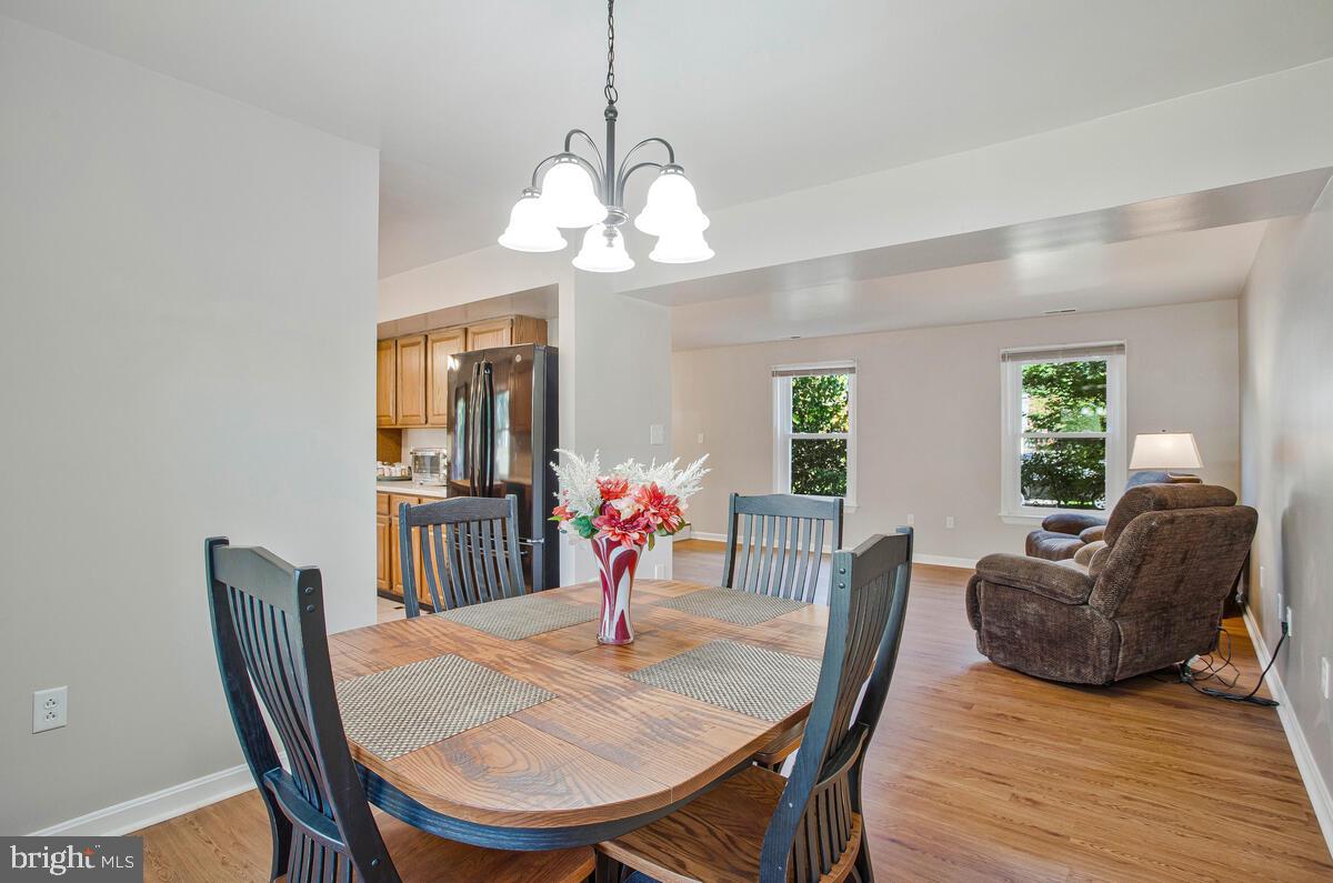 645 Gull Drive Deale, MD 20751 - Photo 20 of 41 a view of a dining room with furniture wooden floor and chandelier