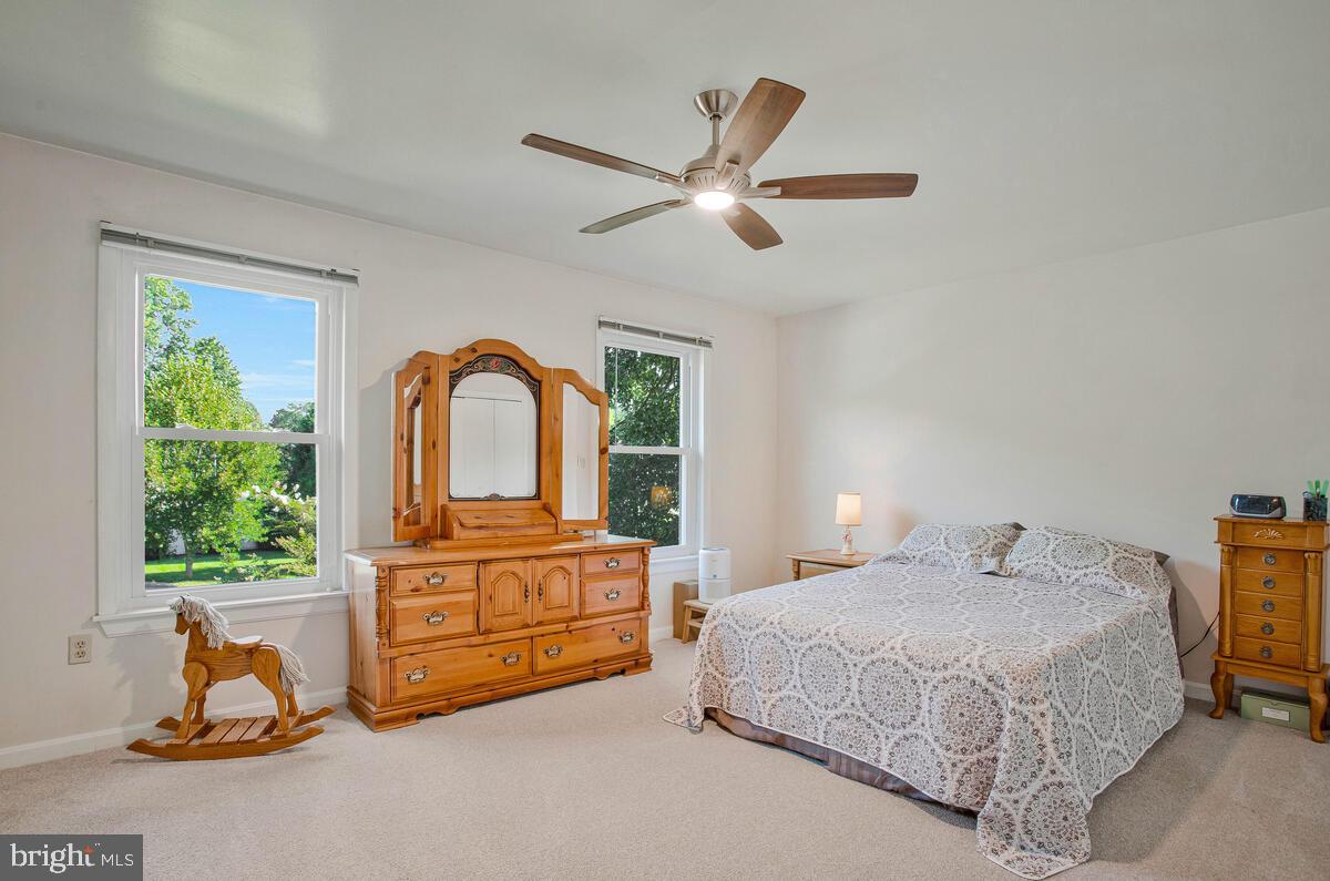 645 Gull Drive Deale, MD 20751 - Photo 23 of 41 a bedroom with a bed and ceiling fan