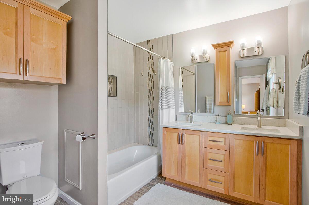 645 Gull Drive Deale, MD 20751 - Photo 25 of 41 a bathroom with a granite countertop sink a toilet and a bathtub
