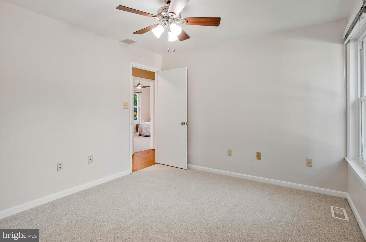 645 Gull Drive Deale, MD 20751 - Photo 28 of 41 an empty room with closet and a chandelier fan