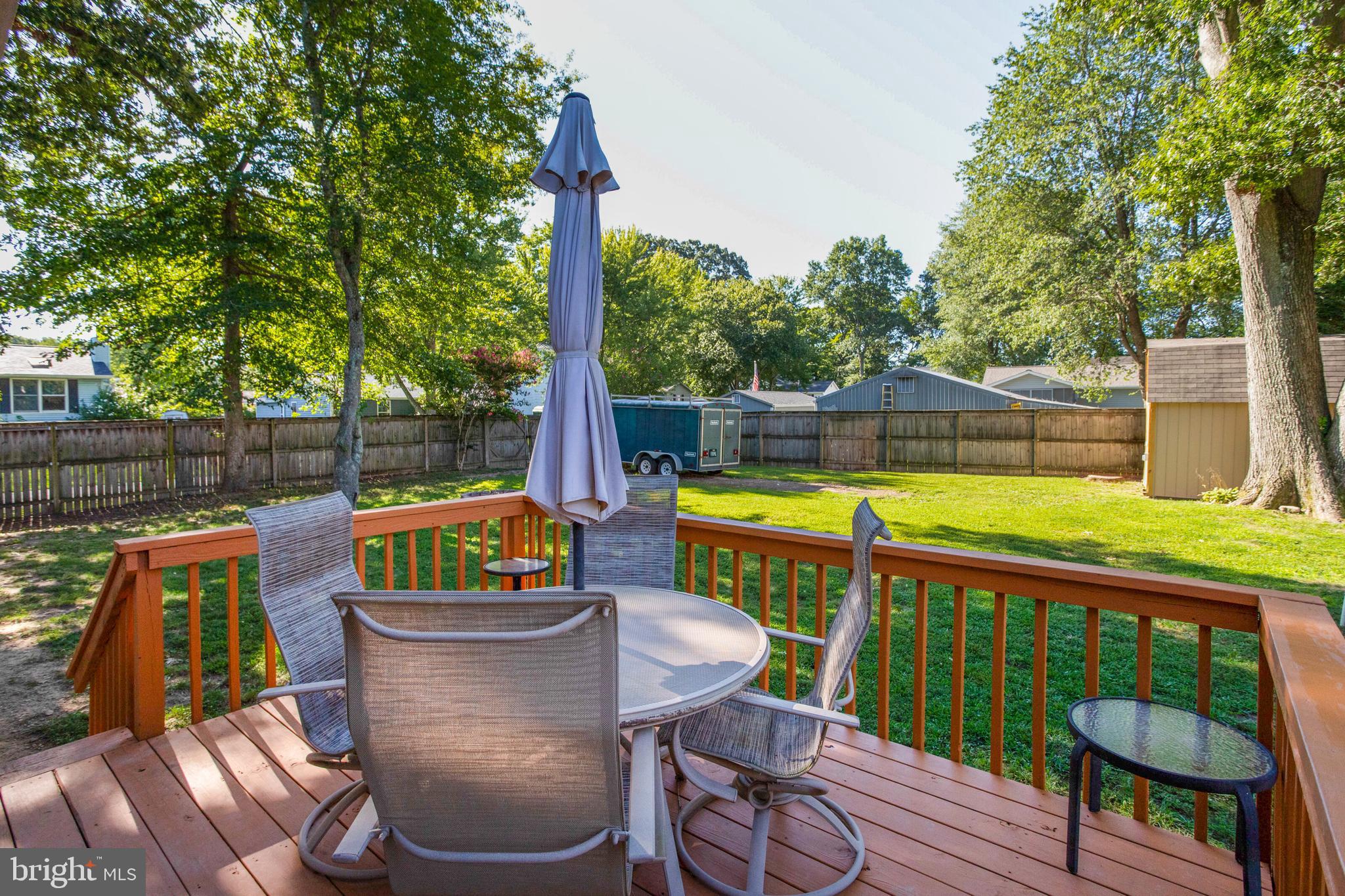 645 Gull Drive Deale, MD 20751 - Photo 36 of 41 a view of a chair and tables in the deck under a large tree