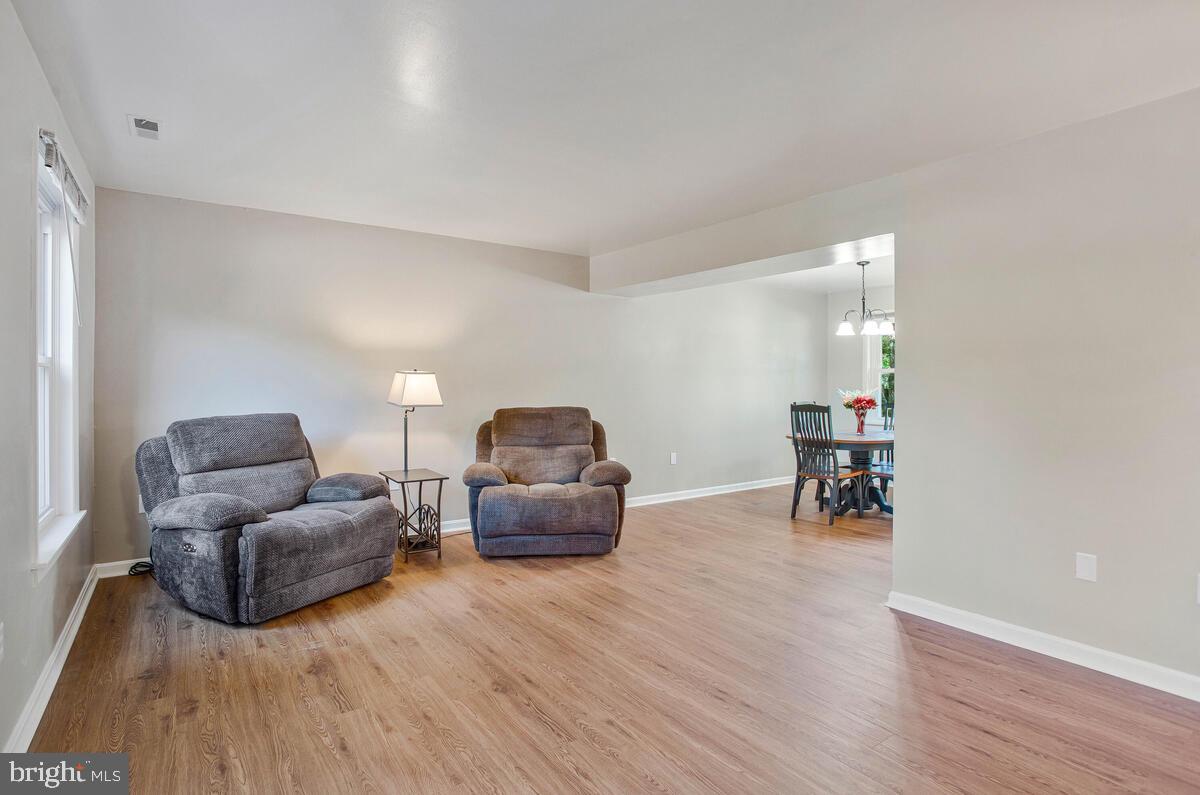 645 Gull Drive Deale, MD 20751 - Photo 8 of 41 a living room with furniture and a wooden floor