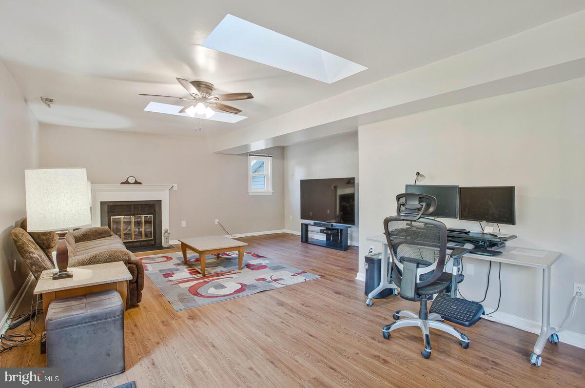 645 Gull Drive Deale, MD 20751 - Photo 9 of 41 a living room with furniture a fireplace and a flat screen tv