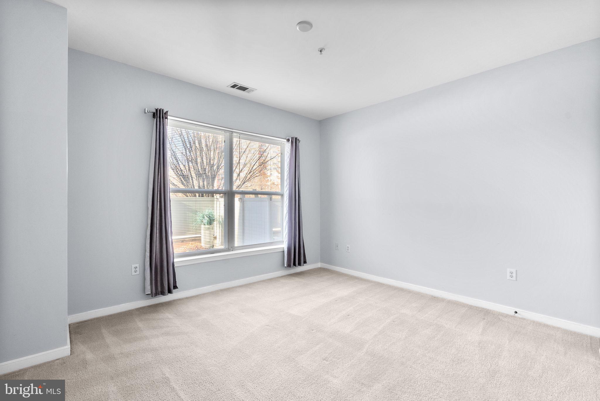 8045 Newell Street, Unit 116 Silver Spring, MD 20910 - Photo 17 of 28 an empty room with windows