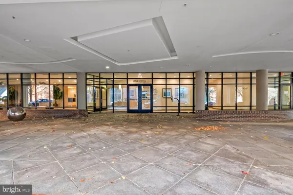 a view of a bathroom with wooden floor and white walls
