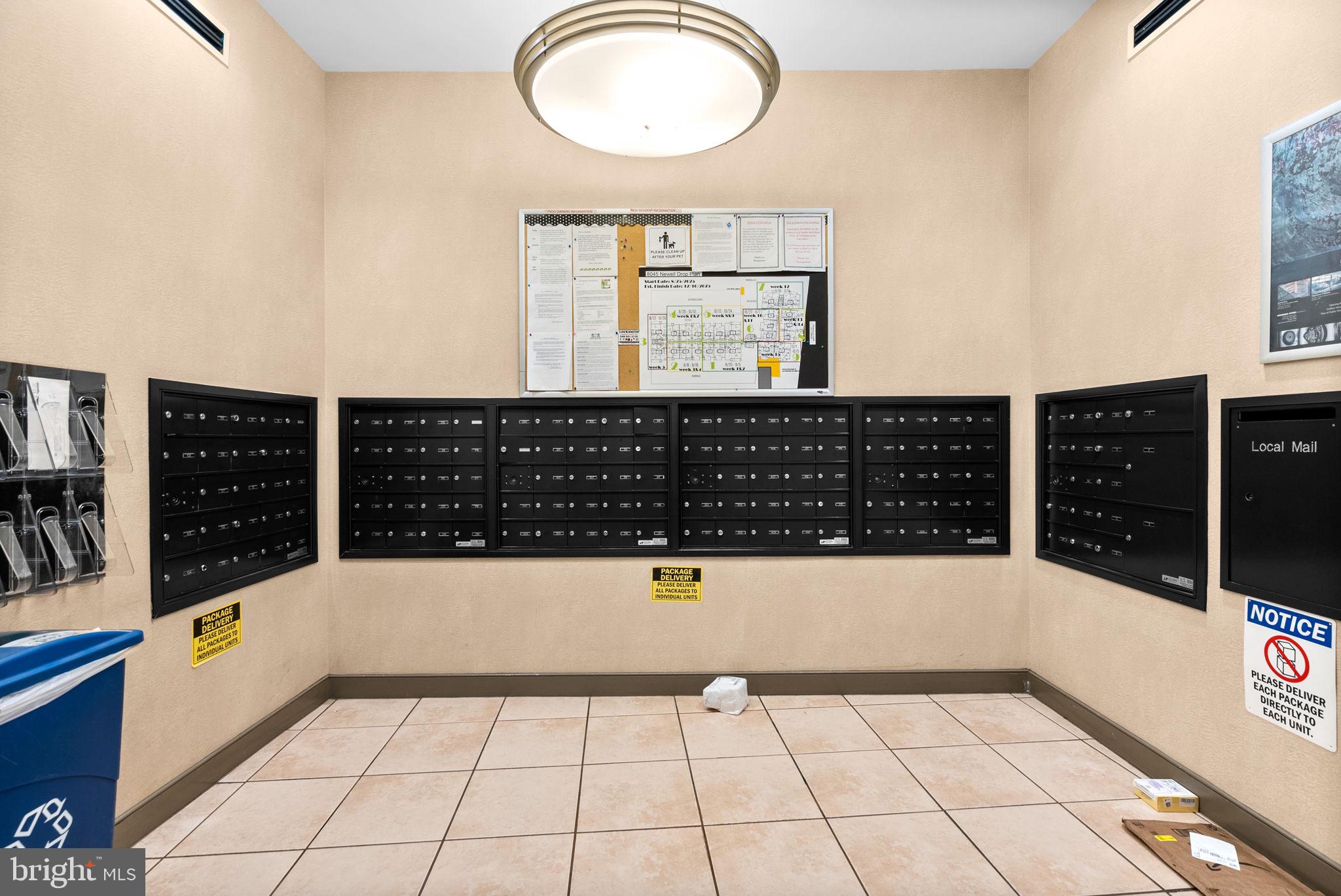 8045 Newell Street, Unit 116 Silver Spring, MD 20910 - Photo 25 of 28 a view of a bathroom with wooden floor and white walls