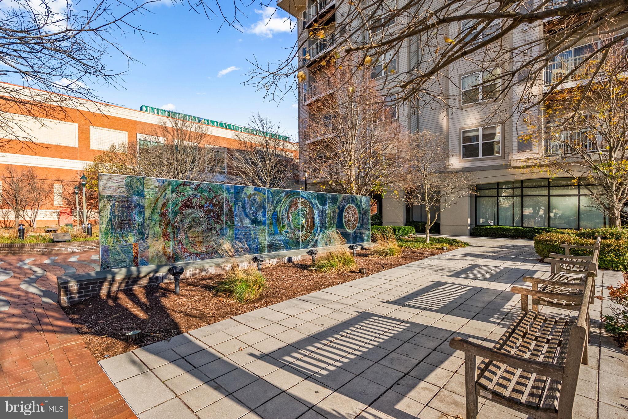 8045 Newell Street, Unit 116 Silver Spring, MD 20910 - Photo 26 of 28 a view of a patio with couches and table and chairs and potted plants