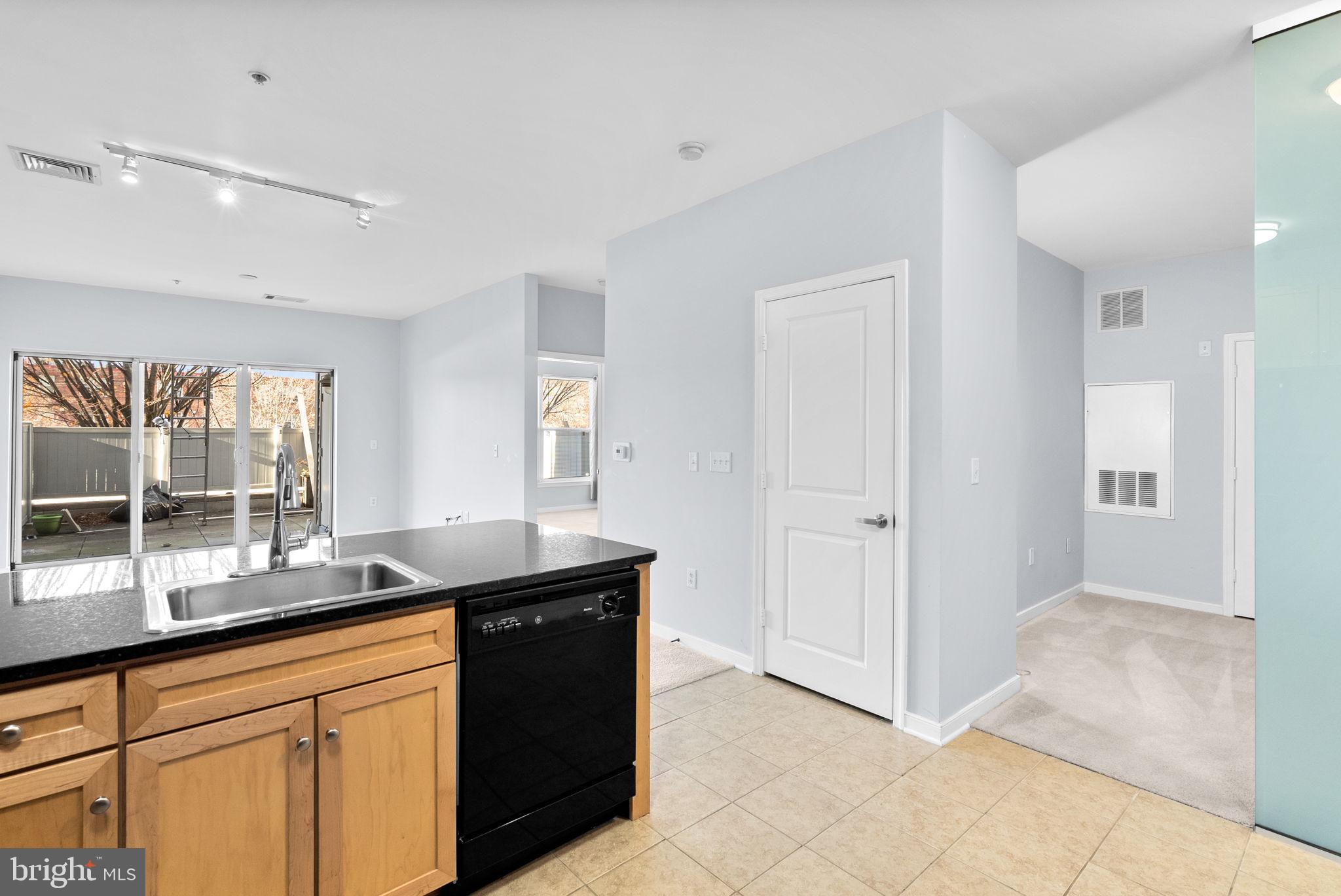 8045 Newell Street, Unit 116 Silver Spring, MD 20910 - Photo 7 of 28 a kitchen with granite countertop a sink and a granite counter tops