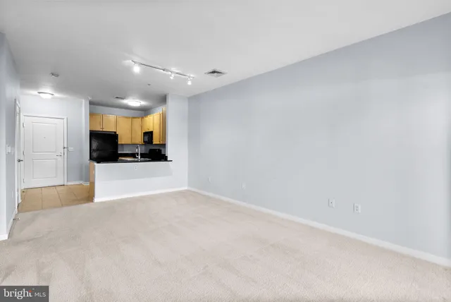 an empty room with a kitchen and a sink