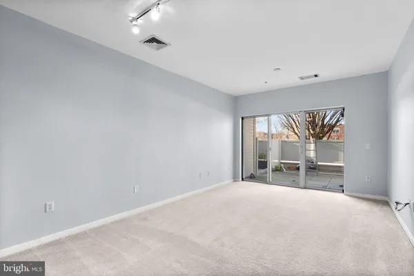 a view of an empty room with a window