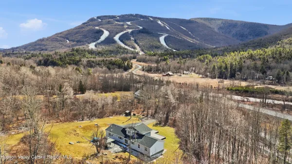 a view of a house with a yard and a large window