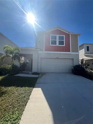a view of house with backyard