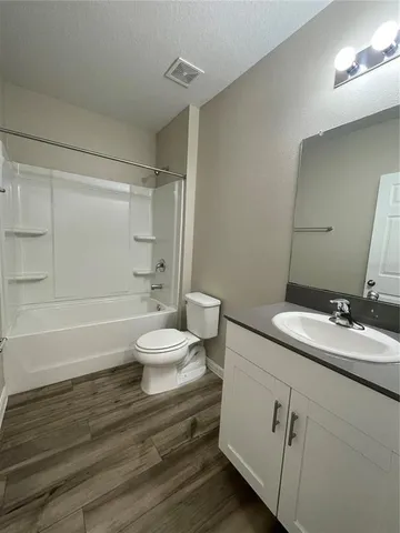 a bathroom with a double vanity sink toilet and shower