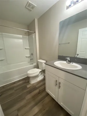 a bathroom with a double vanity sink toilet and shower