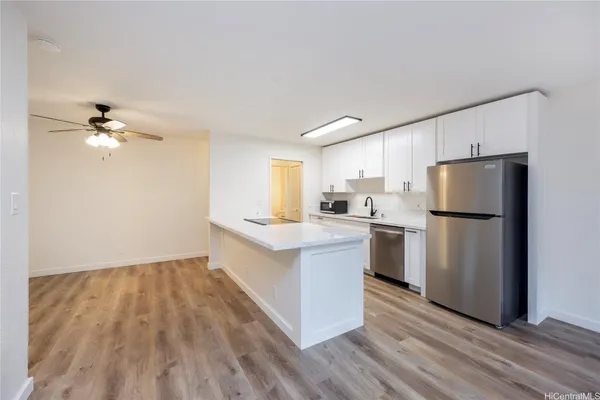 a kitchen with white cabinets and stainless steel appliances