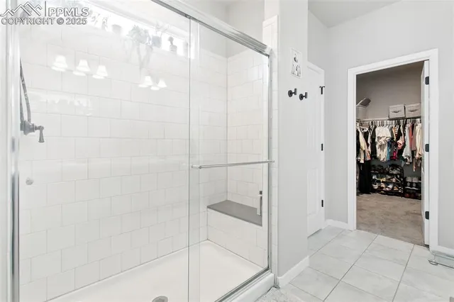 a bathroom with a glass shower door