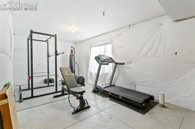 a room with gym equipment and windows
