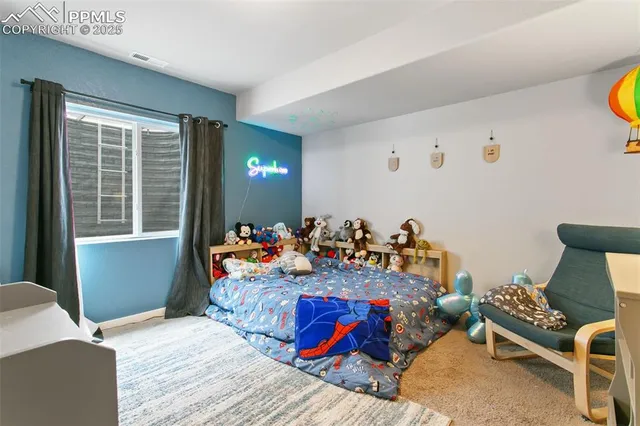 a bed room with a bed and a chair