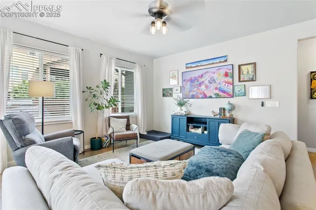 a living room with furniture a fireplace and a large window