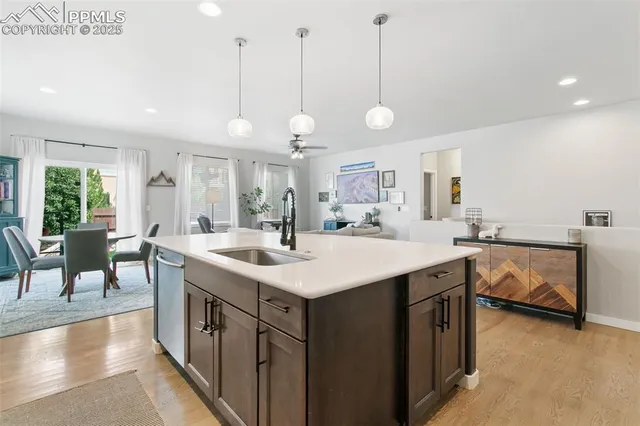 a large kitchen with kitchen island a sink table and chairs